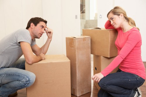 Removalists efficiently loading furniture into a moving truck in Brent